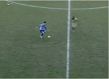 A Group Of Soccer Players Are Playing On A Field And One Of Them Is Wearing A Blue And White Striped Shirt GIF