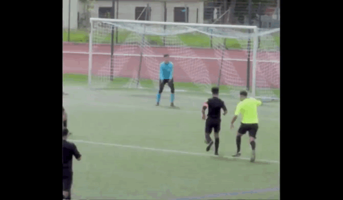 A Group Of Soccer Players Are Playing On A Field And One Of Them Is Wearing A Blue Jersey GIF