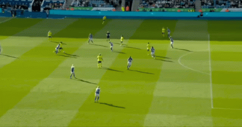 A Group Of Soccer Players Are Playing On A Field And One Of Them Is Wearing A Yellow Shirt GIF