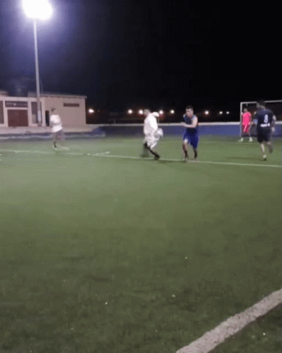 A Group Of Soccer Players Are Playing On A Field At Night And One Of Them Is Wearing A Number 8 Jersey GIF