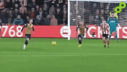 A Group Of Soccer Players Are Playing On A Field . GIF