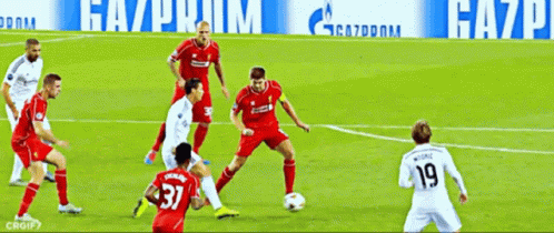 A Group Of Soccer Players Are Playing On A Field With A Gazprom Banner Behind Them GIF