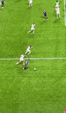 A Group Of Soccer Players Are Playing On A Field With A Goal In The Background GIF