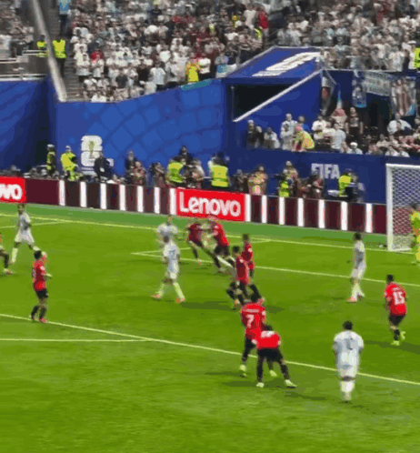 A Group Of Soccer Players Are Playing On A Field With A Lenovo Sign Behind Them GIF