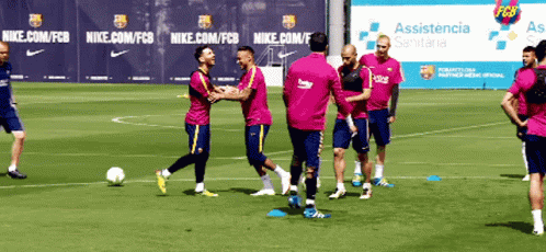 A Group Of Soccer Players Are Playing On A Field With A Nike Banner In The Background GIF