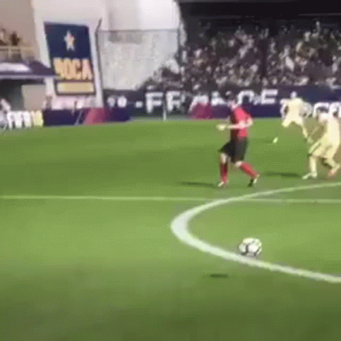 A Group Of Soccer Players Are Playing On A Field With A Sign That Says Boca On It GIF