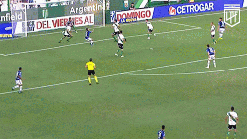 a group of soccer players are playing on a field with an advertisement for banfield behind them