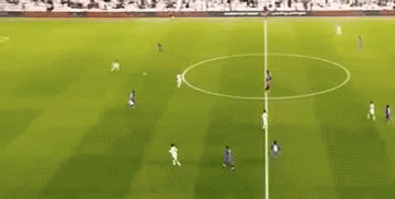 A Group Of Soccer Players Are Playing Soccer On A Field . GIF