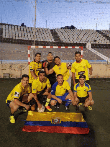A Group Of Soccer Players Are Posing For A Picture With A Flag In Front Of Them GIF