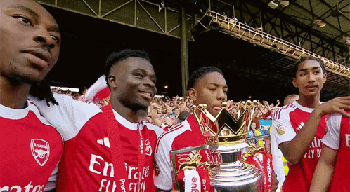 A Group Of Soccer Players Are Posing For A Picture With A Trophy That Says League On It GIF