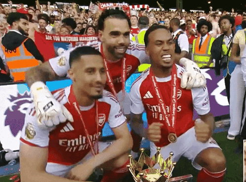 a group of soccer players are posing with a trophy and a sign that says are you watching management