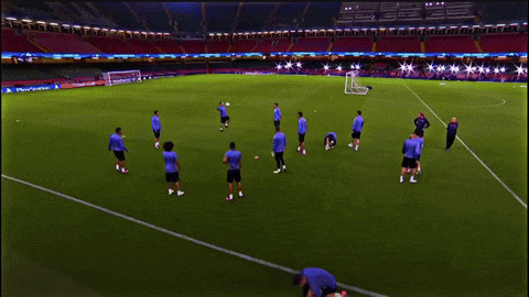 A Group Of Soccer Players Are Practicing On A Field With A Sign That Says ' Allianz ' On It GIF