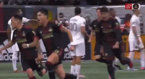 A Group Of Soccer Players Are Running On A Field And One Of Them Has The Number 10 On His Jersey GIF