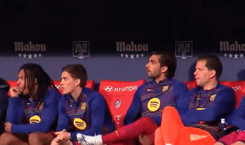 A Group Of Soccer Players Are Sitting On A Couch With Hyundai Written On The Back GIF