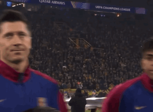 A Group Of Soccer Players Are Standing In Front Of A Crowd With A Qatar Airways Banner In The Background GIF