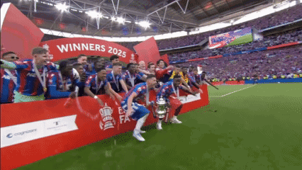 a group of soccer players are standing in front of a sign that says " winners 2025 "