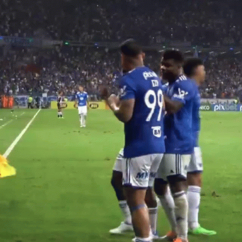 A Group Of Soccer Players Are Standing On A Field And One Of Them Has The Number 99 On His Jersey GIF