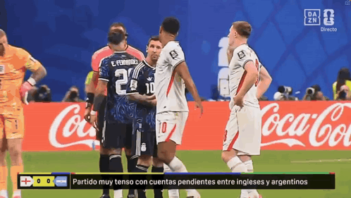 A Group Of Soccer Players Are Standing On A Field In Front Of A Coca Cola Sign GIF