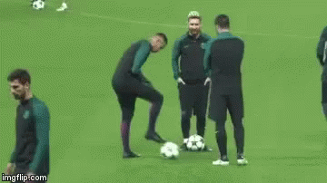 A Group Of Soccer Players Are Standing On A Field With Balls . GIF