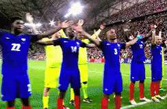 A Group Of Soccer Players Are Standing On A Field With Their Arms Outstretched And One Has The Number 3 On His Shirt GIF