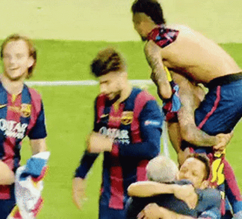 A Group Of Soccer Players Are Standing On Top Of Each Other On A Field . GIF