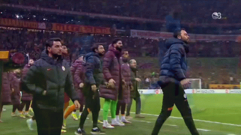 A Group Of Soccer Players Are Walking On A Field With A Banner That Says ' Istanbul ' On It GIF