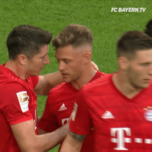 A Group Of Soccer Players From Fc Bayern.tv Are Hugging GIF