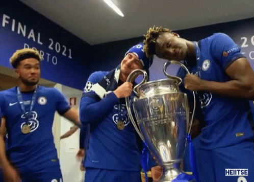 A Group Of Soccer Players Holding A Trophy In Front Of A Wall That Says Final 2021 GIF