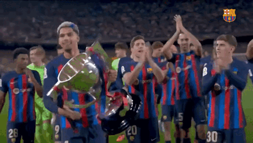 A Group Of Soccer Players Holding A Trophy With The Number 30 On The Back GIF