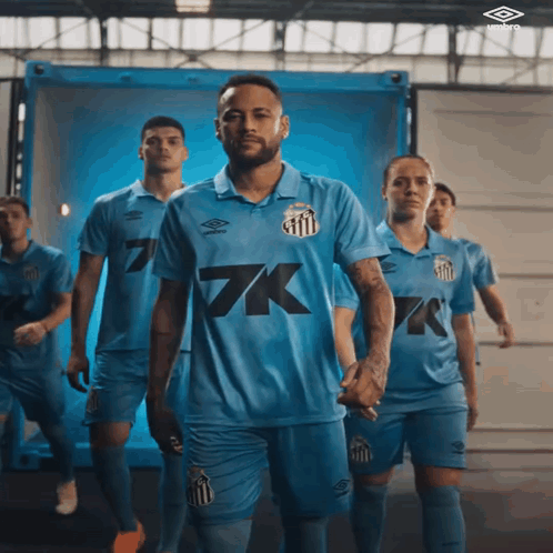 a group of soccer players in blue uniforms with 7k on the front
