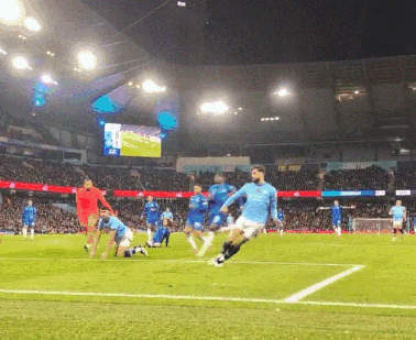 a group of soccer players on a field with a large screen in the background that says ' allianz ' on it