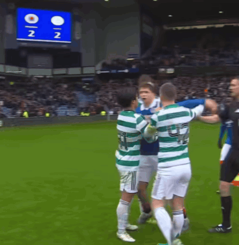 A Group Of Soccer Players On A Field With A Scoreboard In The Background That Says 2 2 GIF