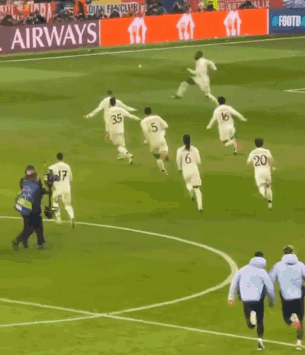 A Group Of Soccer Players On A Field With A Sign That Says That #Uclfeeling GIF
