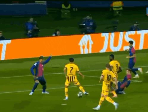 A Group Of Soccer Players On A Field With An Orange Sign That Says Just In The Background GIF