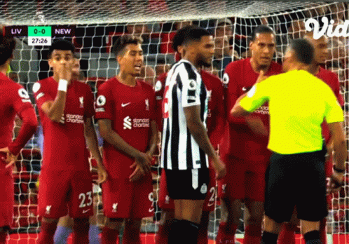 A Group Of Soccer Players Standing Around A Referee Wearing A Yellow Shirt GIF