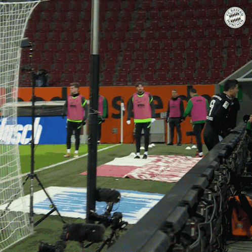 A Group Of Soccer Players Standing On A Field With A Bayern Munchen Logo GIF