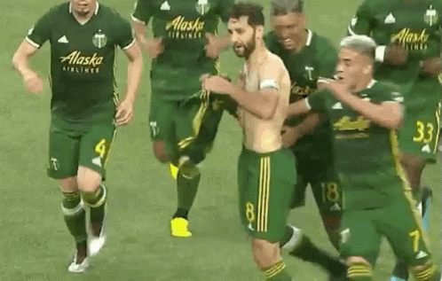 A Group Of Soccer Players Wearing Alaska Airlines Jerseys Are Running On The Field GIF