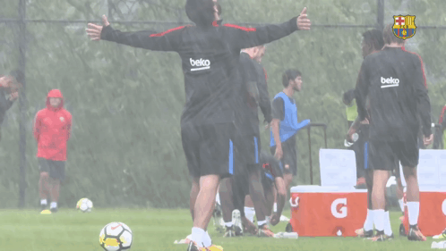 a group of soccer players wearing beko sweatshirts are on a field