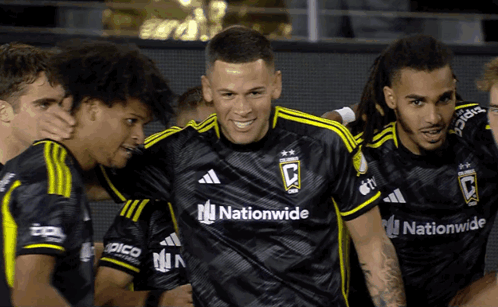 A Group Of Soccer Players Wearing Black Jerseys With The Word Nationwide On Them GIF