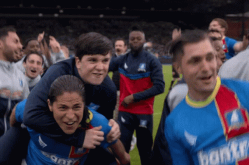 A Group Of Soccer Players Wearing Jerseys That Say Donkey Are Celebrating GIF