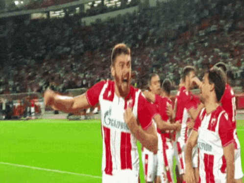 A Group Of Soccer Players Wearing Red And White Jerseys With The Number 11 On Them GIF