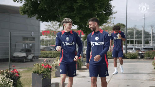 a group of soccer players wearing tezos jerseys