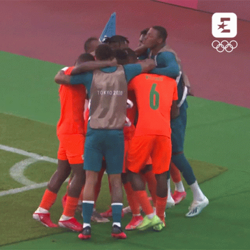 a group of soccer players wearing tokyo 2020 jerseys are huddled together