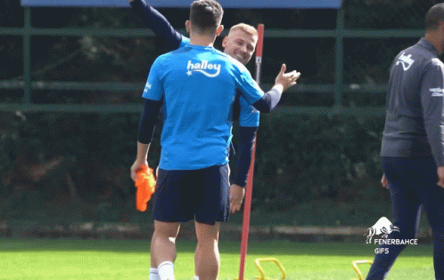 A Group Of Soccer Players With One Wearing A Shirt That Says ' Avi ' On The Back GIF