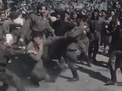 A Group Of Soldiers Are Fighting In A Crowd . GIF