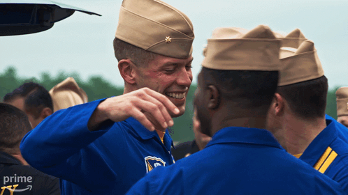A Group Of Soldiers Are Gathered In Front Of A Car With The Word Prime On The Bottom Right GIF