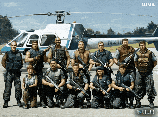 A Group Of Soldiers Are Posing In Front Of A Helicopter That Says Luma On It GIF