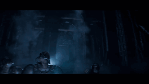 A Group Of Soldiers Are Standing In A Dark Room And One Of Them Is Wearing A Gas Mask GIF