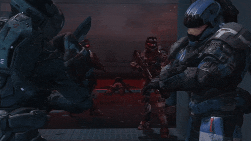 A Group Of Soldiers Are Standing In A Dark Room And One Of Them Is Wearing A Helmet With A T On It GIF