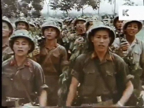 A Group Of Soldiers Are Standing In A Line With The Letter K Visible In The Corner GIF
